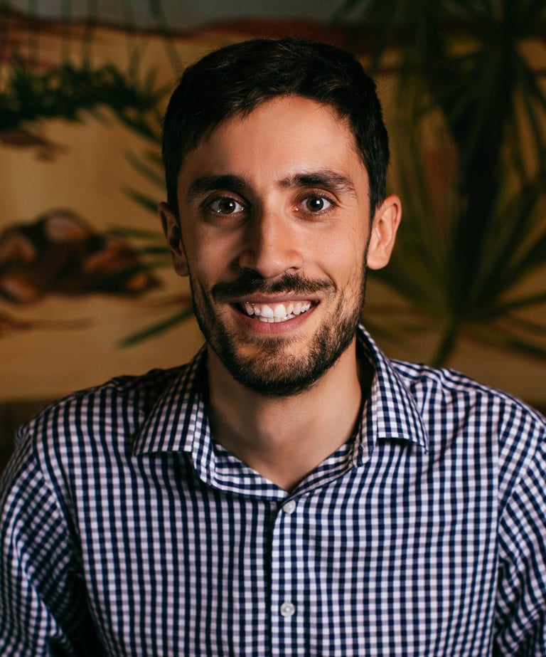 John William, a math and economics tutor, smiling in a professional headshot.