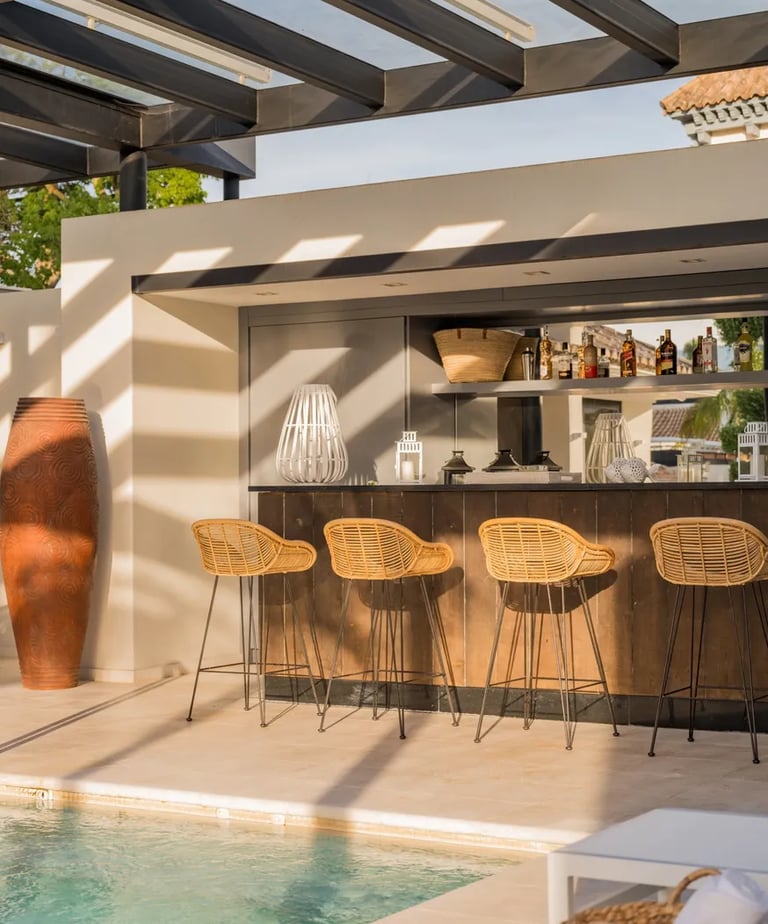 Outdoor bar and lounge area by the pool at Villa El Olivo, Marbella