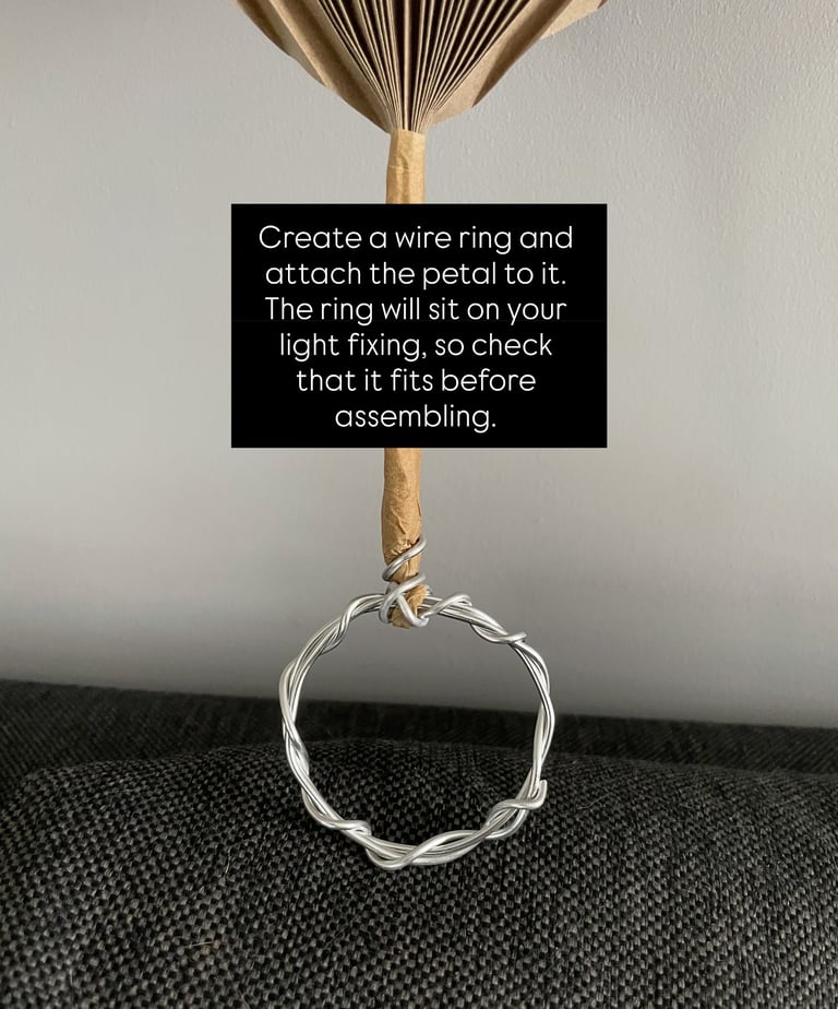 accordion-style folded flower petal for DIY lamp shade, taped with brown paper tape and wire ring