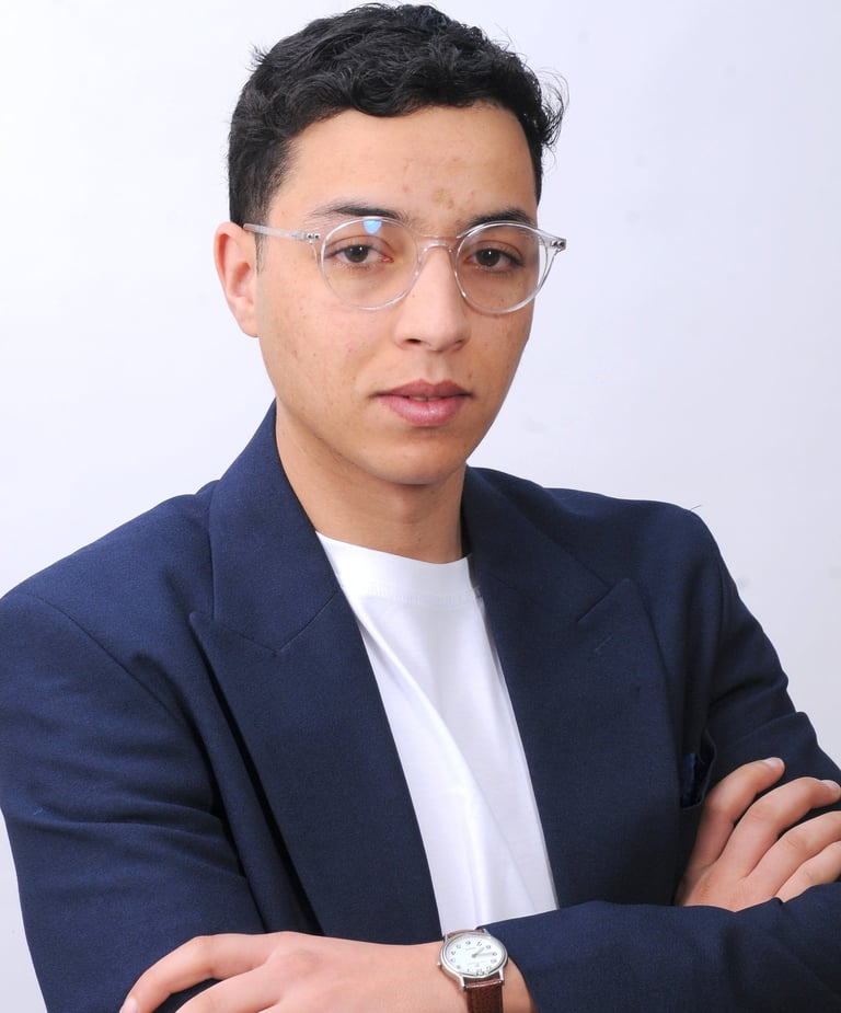 a man in a suit and glasses with a watch on his wrist