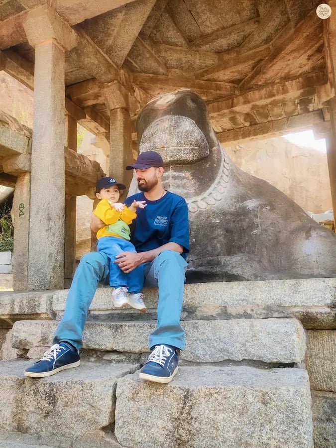 Parent with child at Big Nandi, the guardian statue of Hampi.