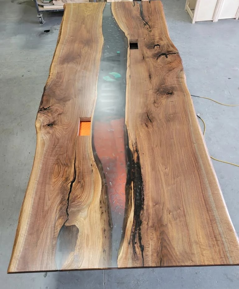 Custom black walnut epoxy river boardroom table — production top view