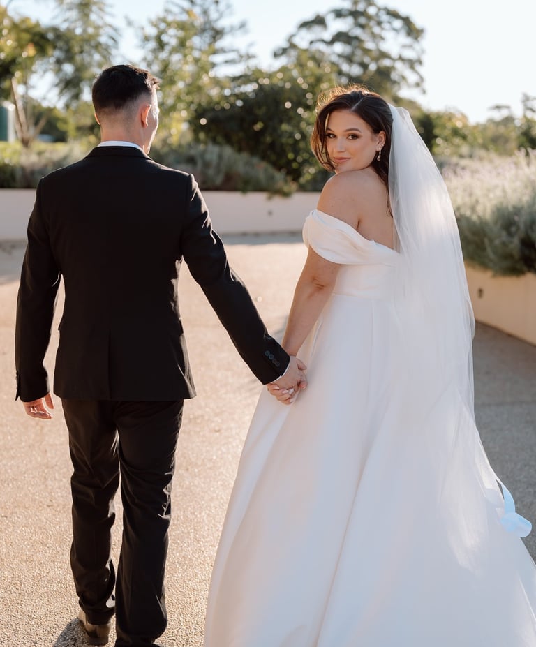 Bride and groom with white dress and black suit wedding makeup and hair