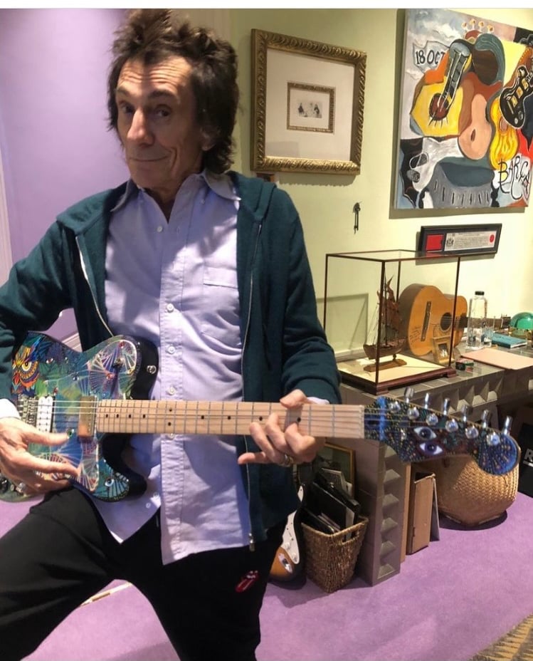 Ronnie Wood of the Rolling Stones singing - autographing my painted guitar.