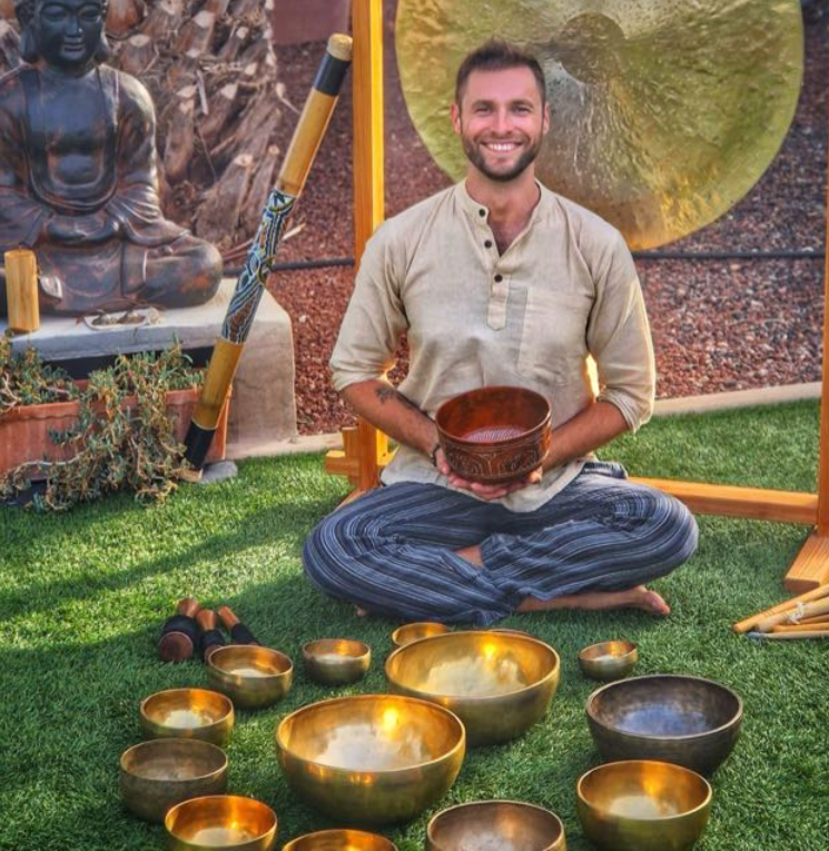 csaba seated in the middle of all sound therapy  instruments