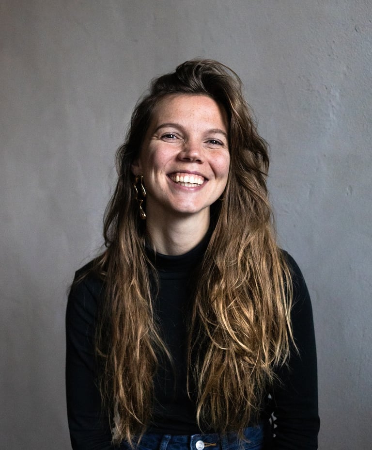 Young, female public speaking trainer, smiling in the camera confidently and happy