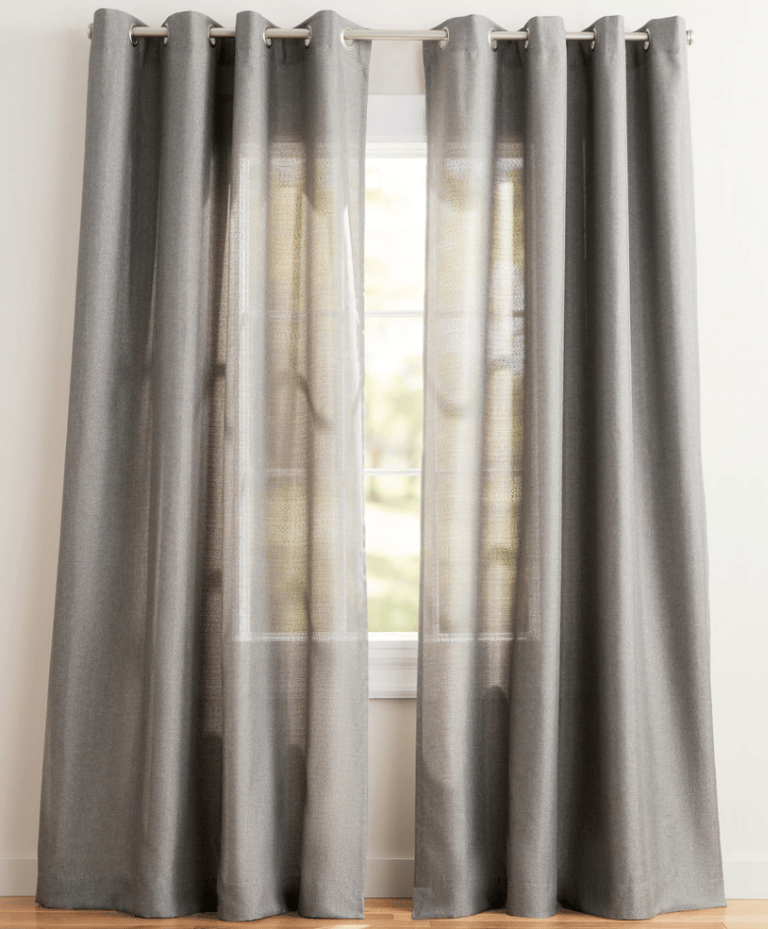 Modern grey linen grommet curtains hanging on a window for elegant home decor and privacy.