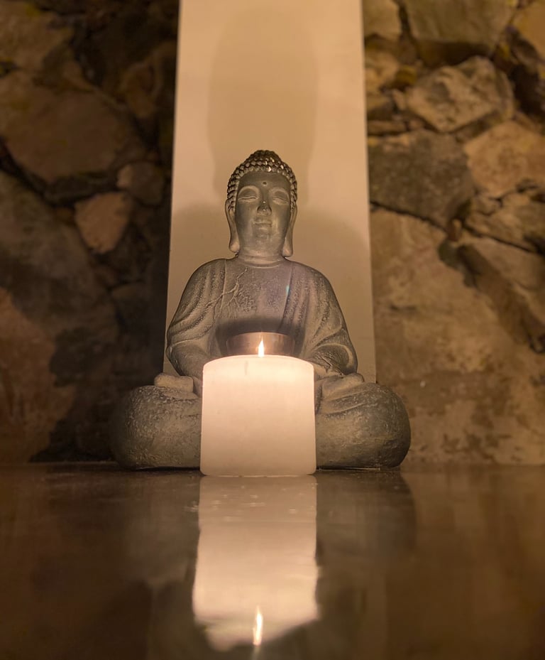 buddah statue with candle in front