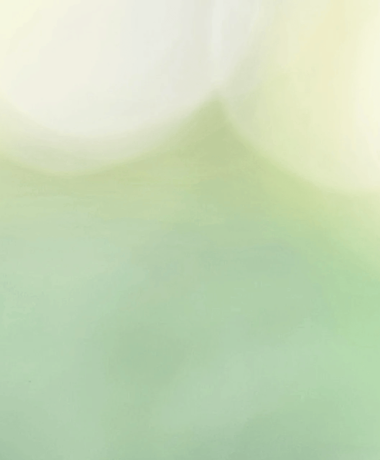 Abstract, luminous field of soft sage green dissolving into large, glowing white bokeh orbs.