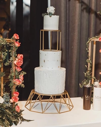 a cake with a gold frame and flowers