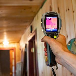 mold remediation technician inspecting basement wall in Ottawa home
