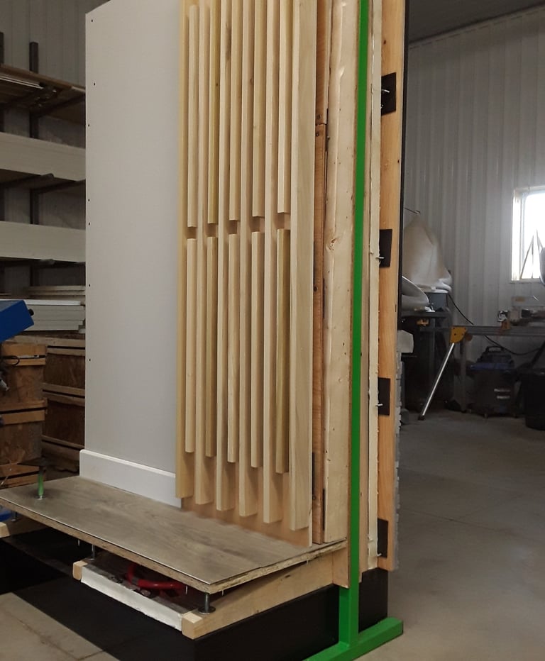 Interior wall mock-up with decorative wood slat paneling and raised flooring system for design and construction display