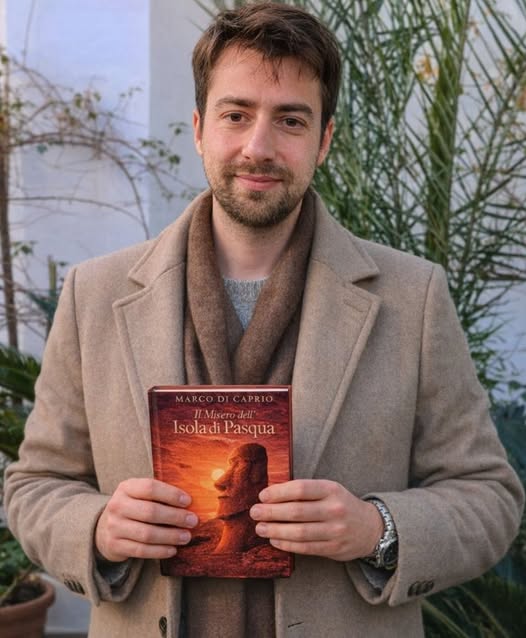 Marco Di Caprio holding the Italian version of his book