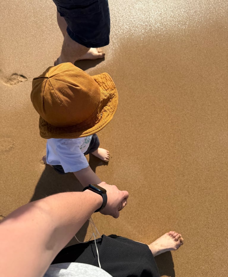 Founder of Soft Strength Mother walking on the beach holding hands with her son