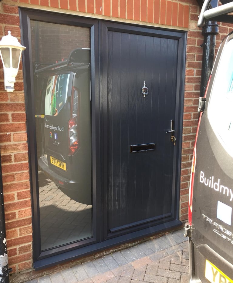 modern composite door with side panel and reflective glass.  the door has chrome hardware
