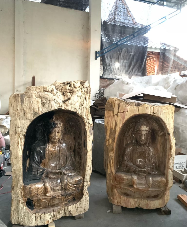 Two Buddha sculptures carved within solid petrified wood blocks — Part of Arcanum.