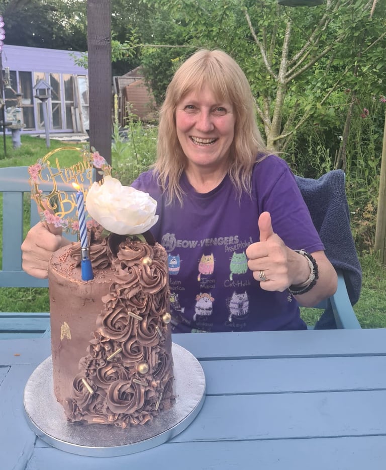 Patsy in our garden with a birthday cake