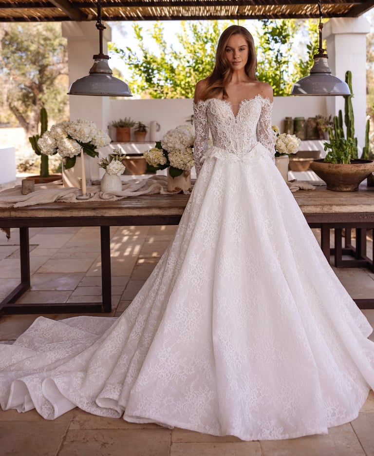 a woman in a wedding dress standing in front of a table