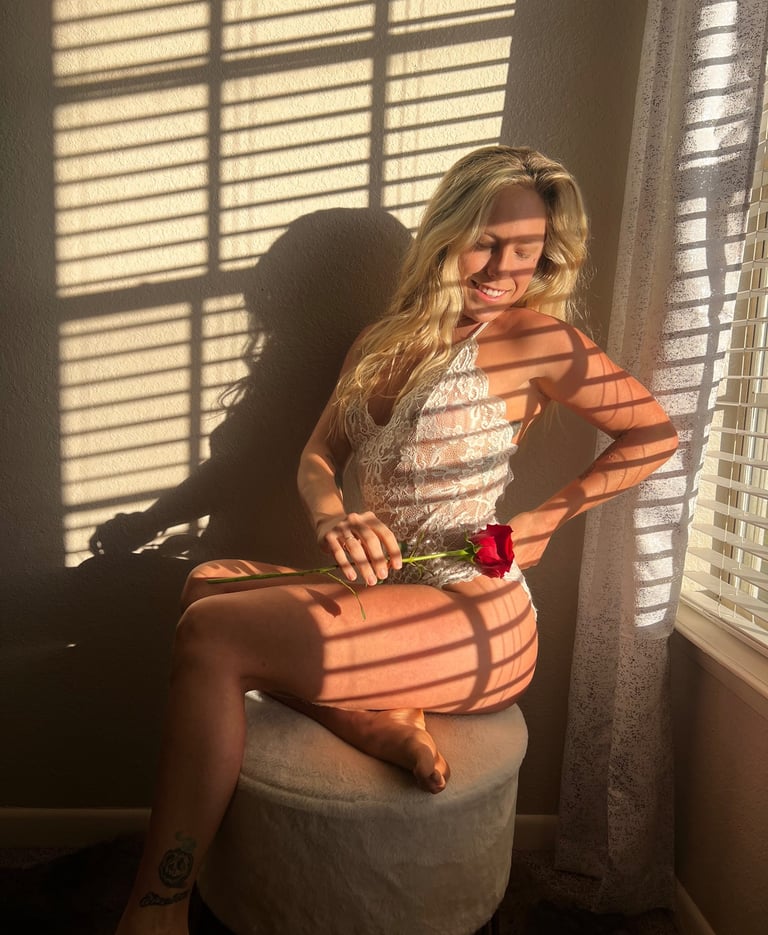 a woman in a white lingerie sitting on a stool