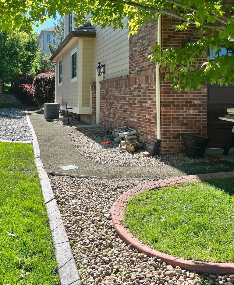 A sleek 3.5-foot grey breeze walkway with galvanized edgingand an integrated French drain system.