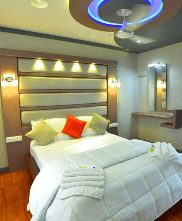a bed with a large bed and a ceiling fan