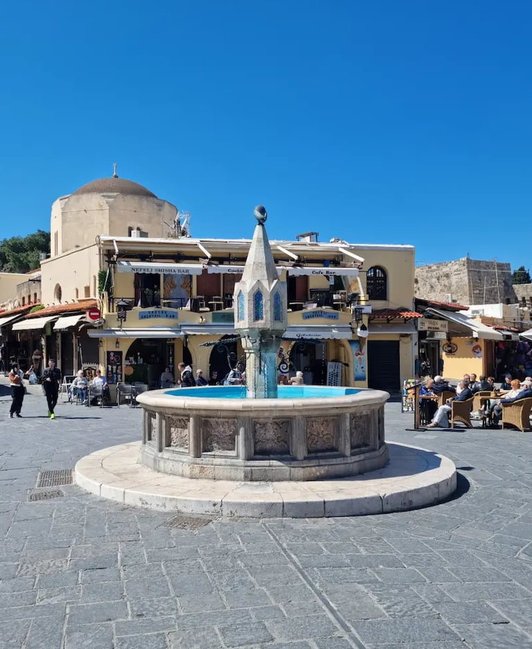 a fountain fountain in a square in a town