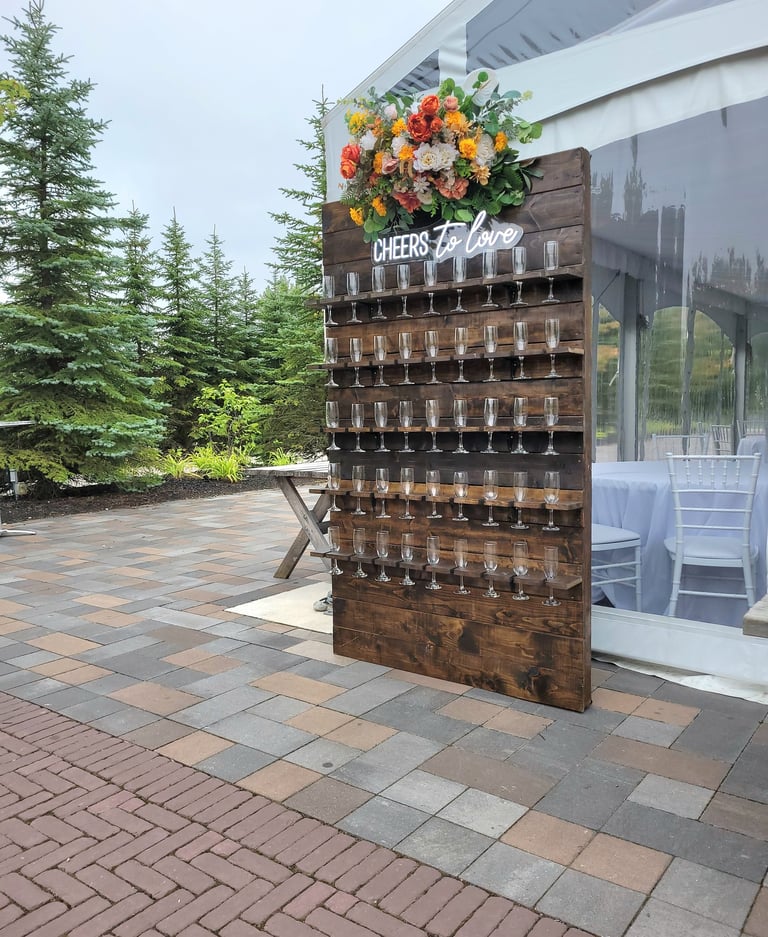 Custom made brown stained champagne wall for an outdoor wedding with fall florals