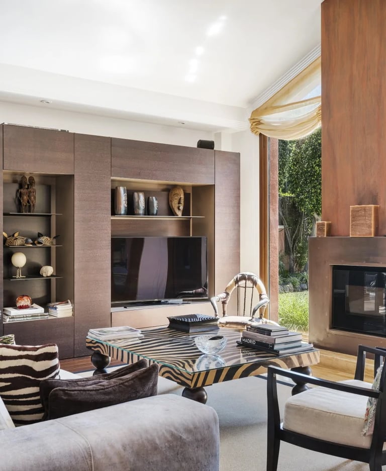 Elegant living room with fireplace overlooking the gardens of a luxury Marbella villa