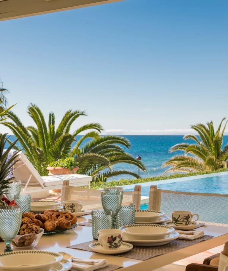 Outdoor breakfast terrace overlooking infinity pool and the sea