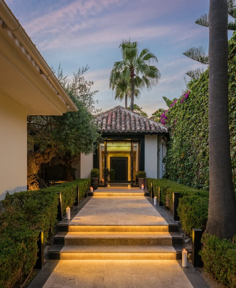 Illuminated villa entrance with stone steps
