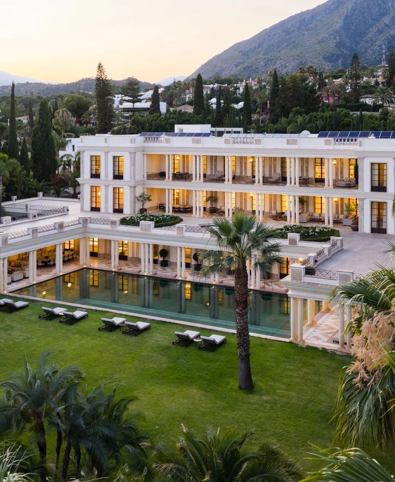 Aerial view of estate at dusk with pool and mountain scenery