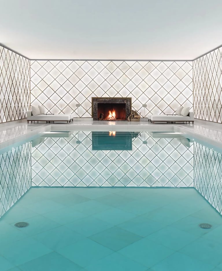 Indoor spa pool with fireplace and tiled walls