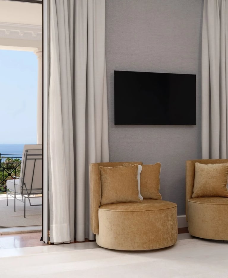 Bedroom lounge with balcony access and distant sea view