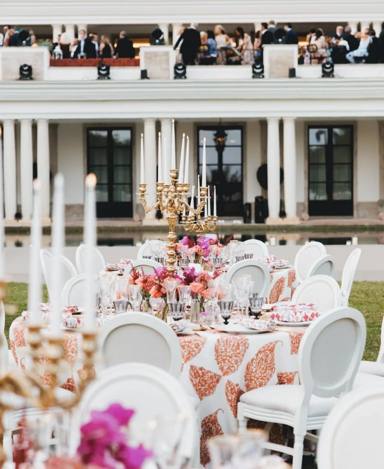 Outdoor banquet setup with round tables and floral décor