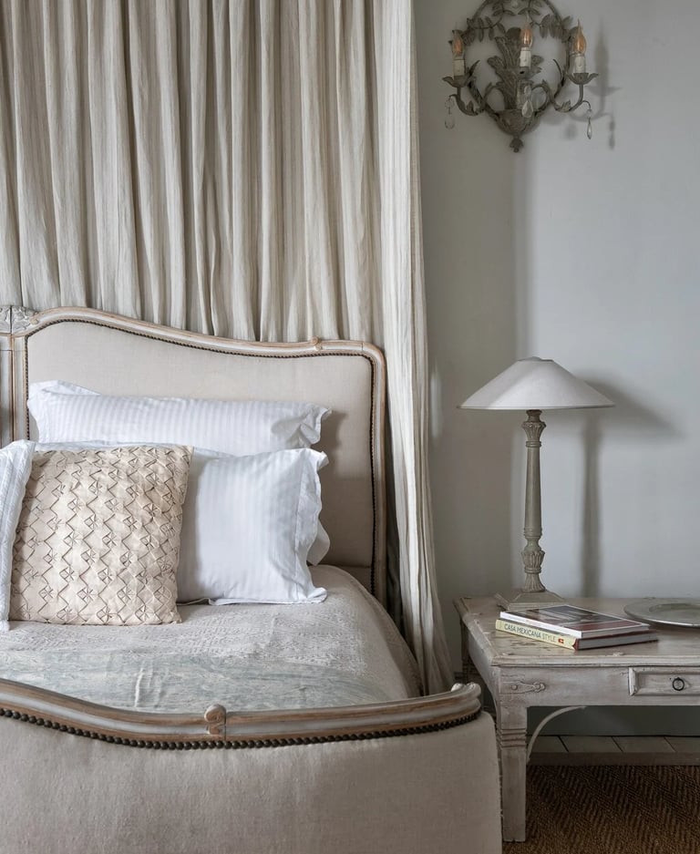 Classic bedroom with neutral tones and tall curtains