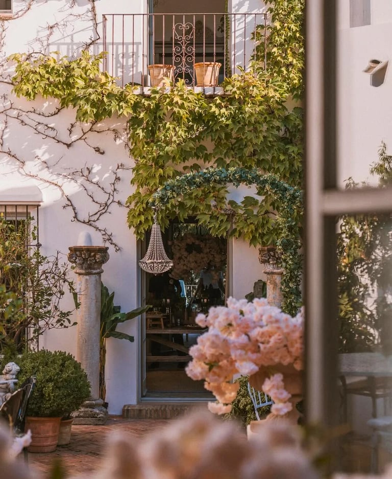 Rustic entrance with climbing greenery and floral details