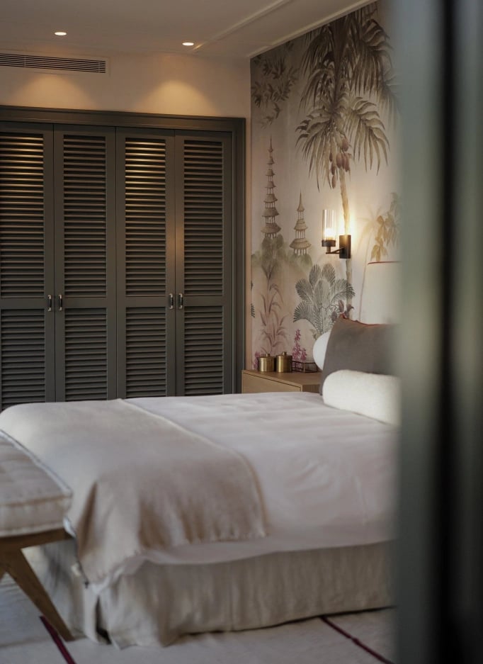 Bedroom with mural feature wall and fitted wardrobes