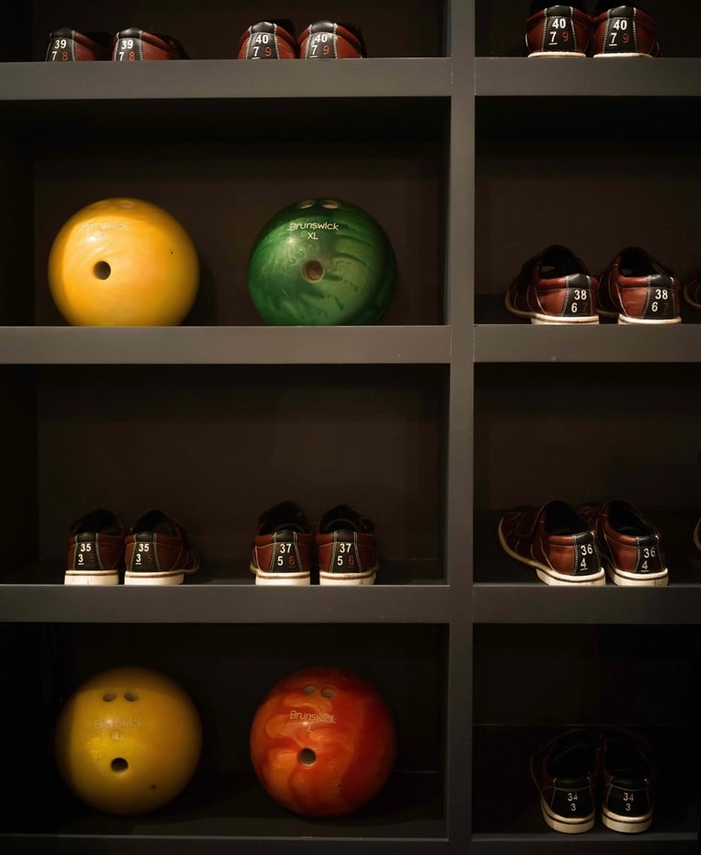 Shelving with bowling shoes and colorful bowling balls