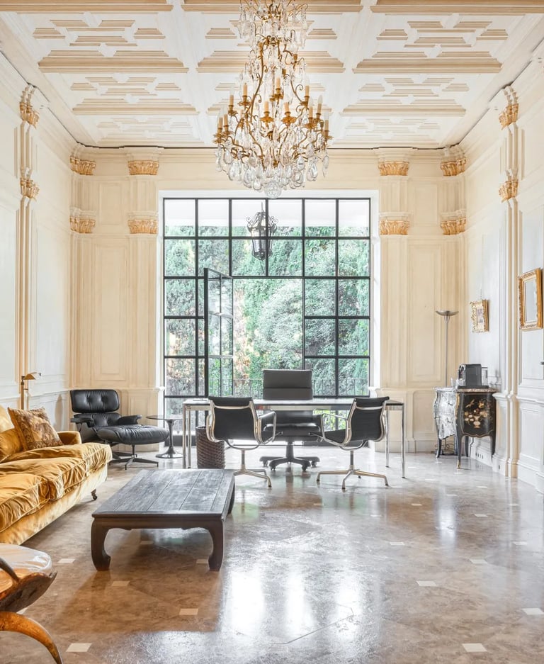 Elegant home office with coffered ceiling, chandelier and marble fireplace