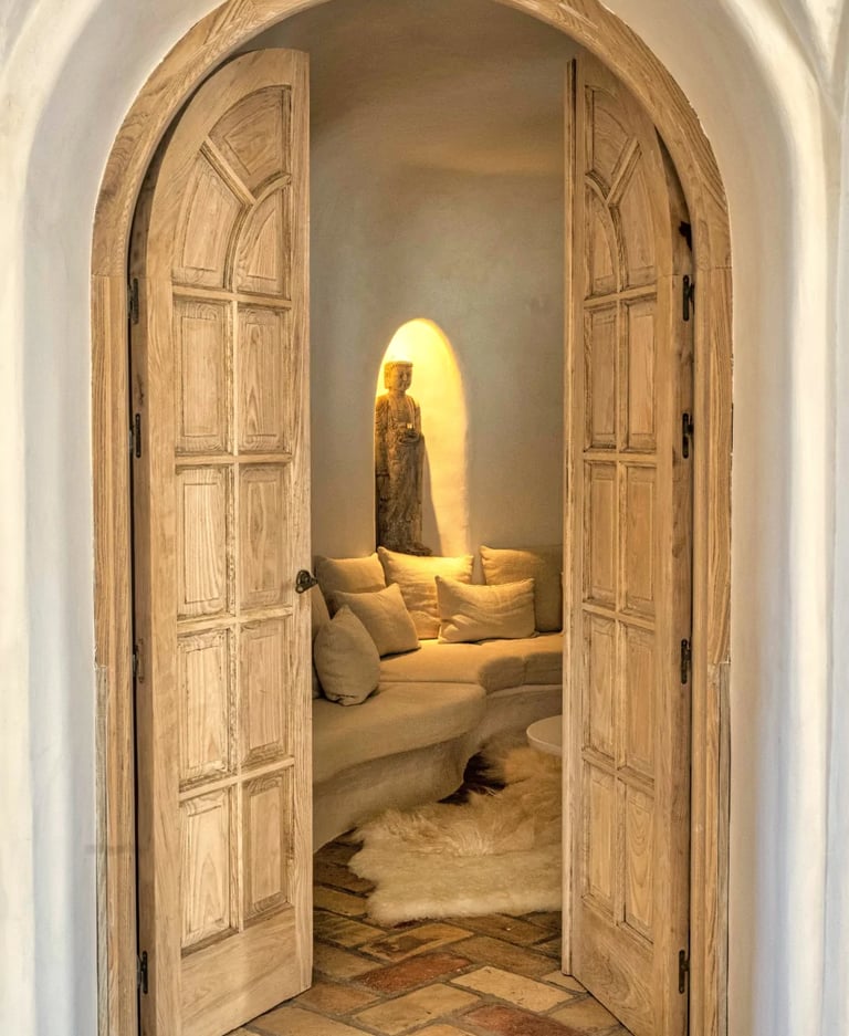 Arched wooden doors opening to intimate meditation lounge