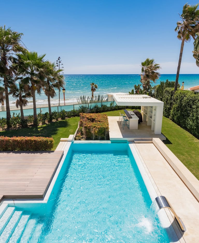 Beachfront pool and garden with outdoor bar pavilion