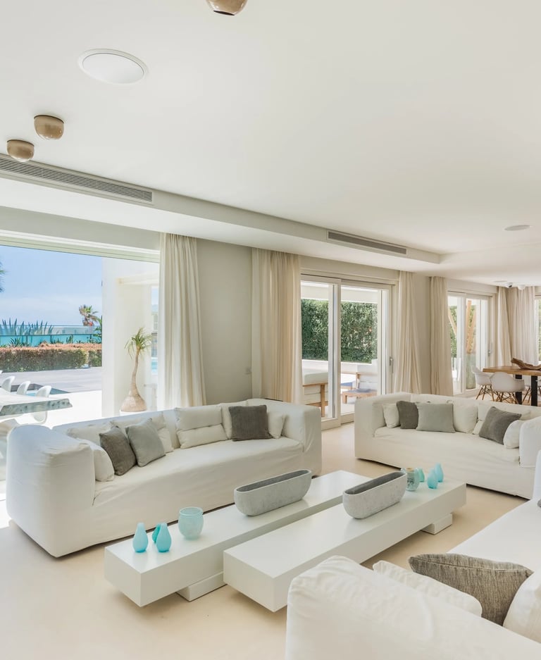 Bright living room with ocean views and terrace access