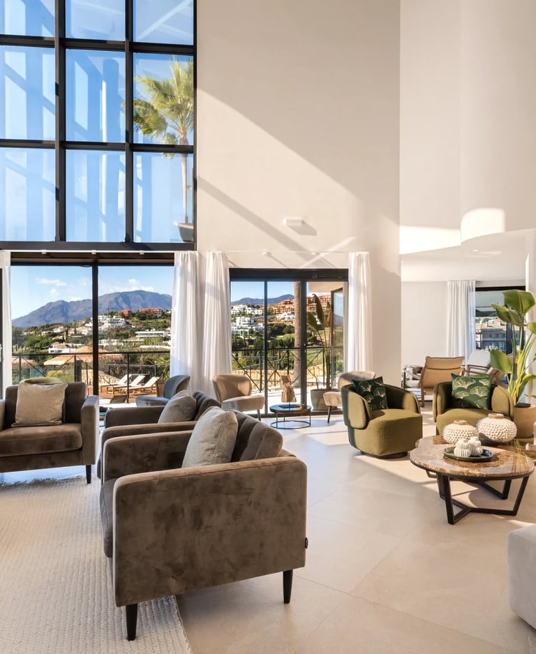 Double height living room with fireplace and terrace views