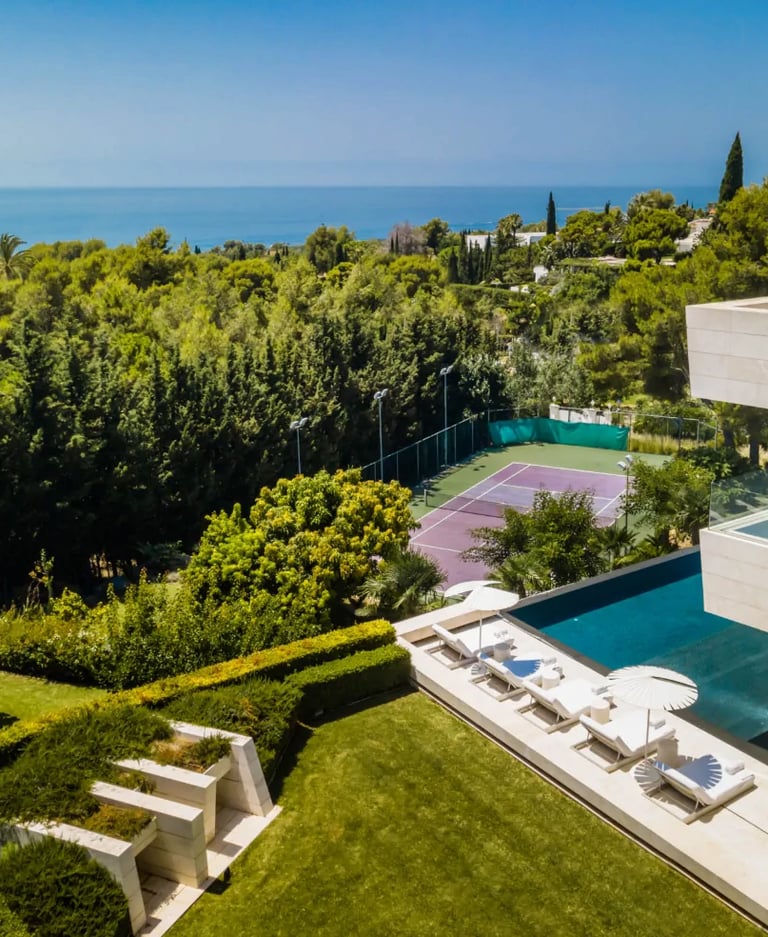 Infinity pool and tennis court with sea views