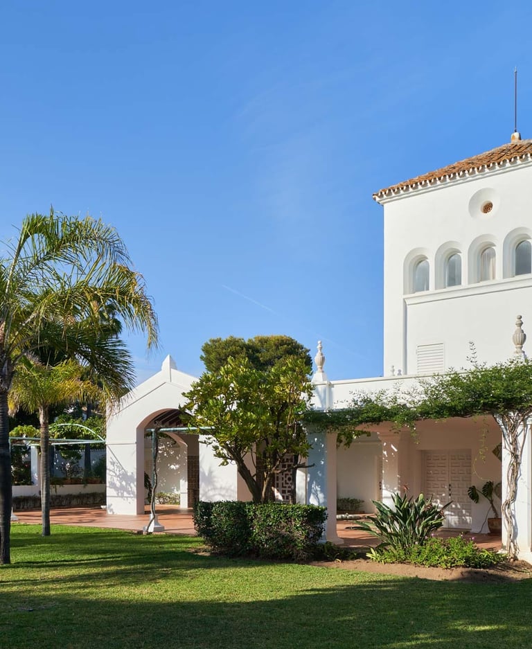 Andalusian villa façade with tower and gardens