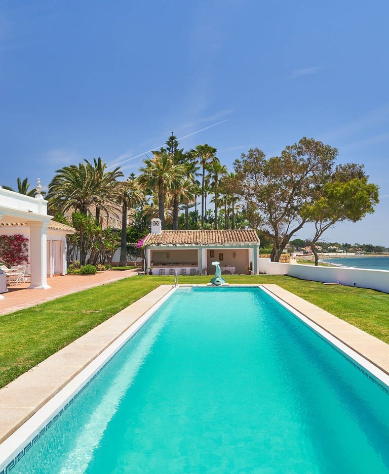 Beachfront pool and lawn overlooking the sea