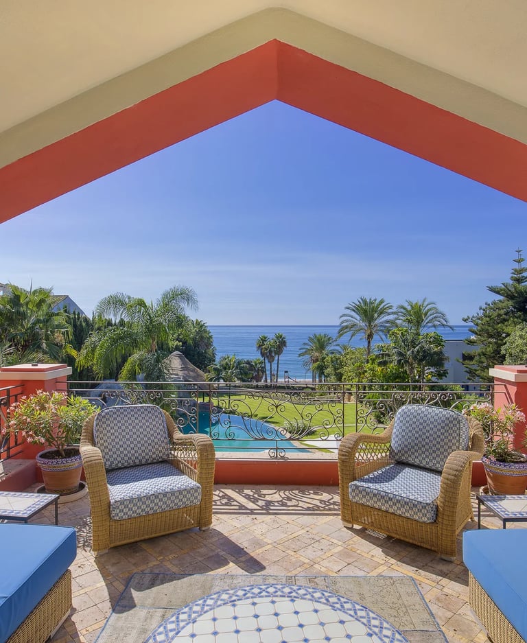Covered terrace overlooking the beachfront gardens and Mediterranean Sea