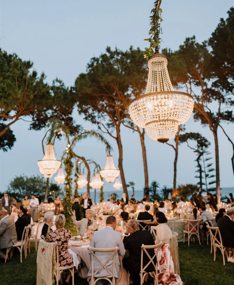 Evening gala dinner under chandeliers by the sea