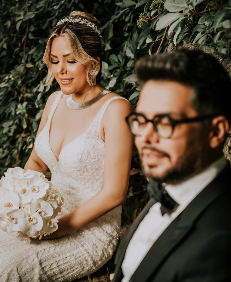 ride holding white orchids beside groom in black tuxedo, captured by Fred Art Studio