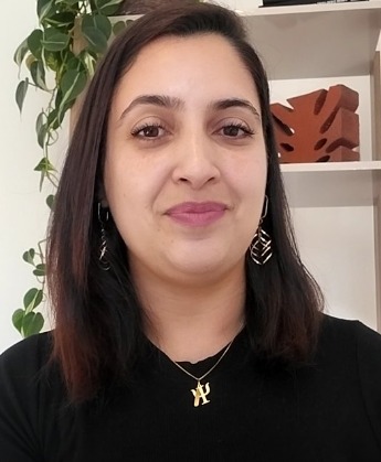 a woman with long hair and earrings on her neck